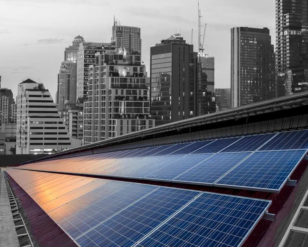 Solar Panel Photovoltaic installation on a Roof of factory, sunny blue sky background, alternative electricity source - Sustainable Resources Concept.